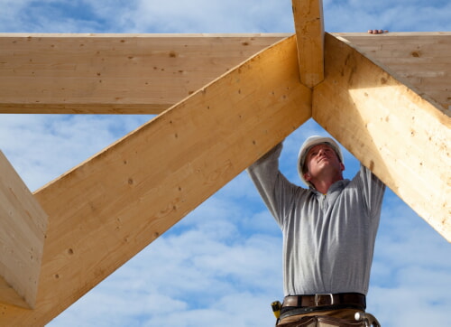 man framing a roof at a jobsite