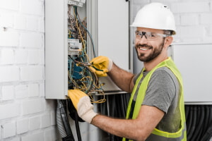 electrician fixing the wiring in an electric panel