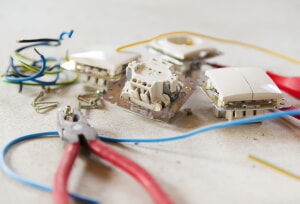 electrician repairing a socket and switch