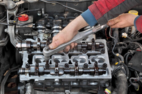 guy working on head of engine