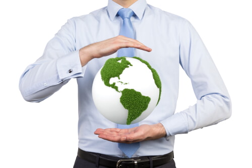 man holding up a green globe eco-friendly