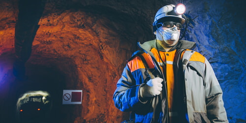 man working in coal mine wearing PPE
