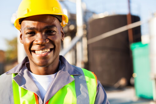 african american petrochemical worker outside factory wearing ppe