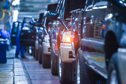 line of trucks being manufactured in an auto assembly plant