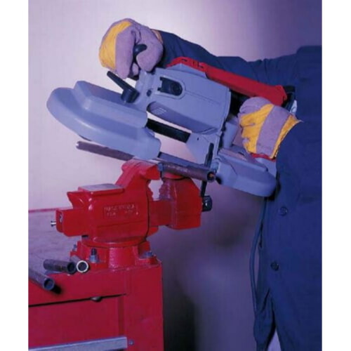 worker safely cutting pipe with bandsaw