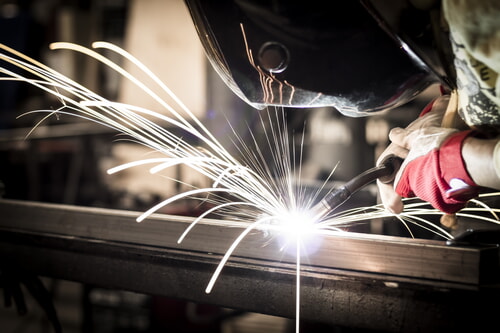 Welder wearing proper PPE for protection from bodily injury