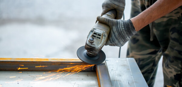 man working with angle grinder